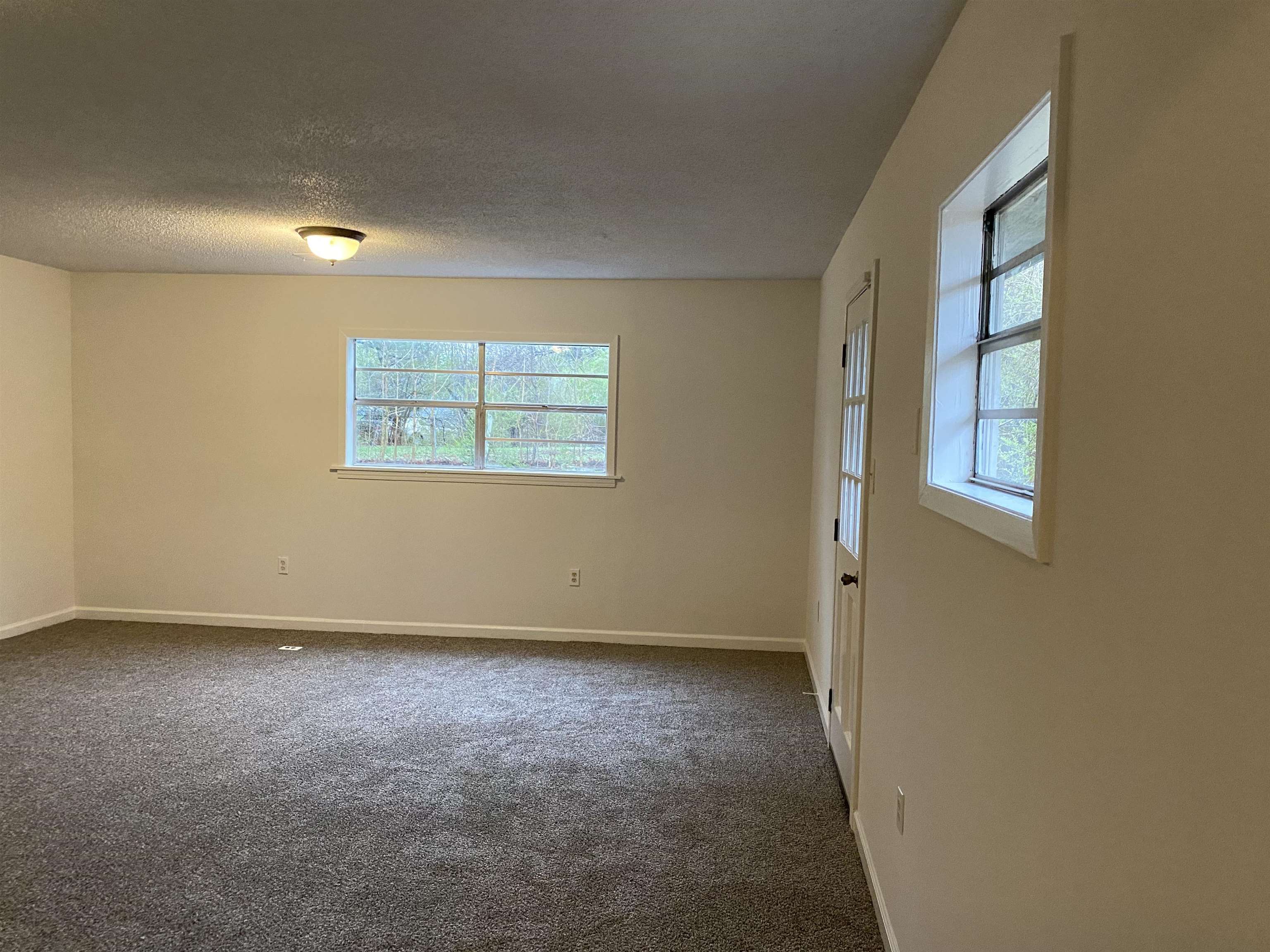 3499 Rochester Road Memphis, TN 38109 - Photo 5 of 14 an empty room with windows