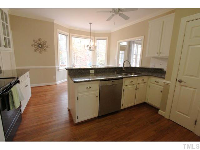 2708 Dahlgreen Road Raleigh, NC 27615 - Photo 5 of 25 a kitchen with a sink cabinets wooden floor and a window
