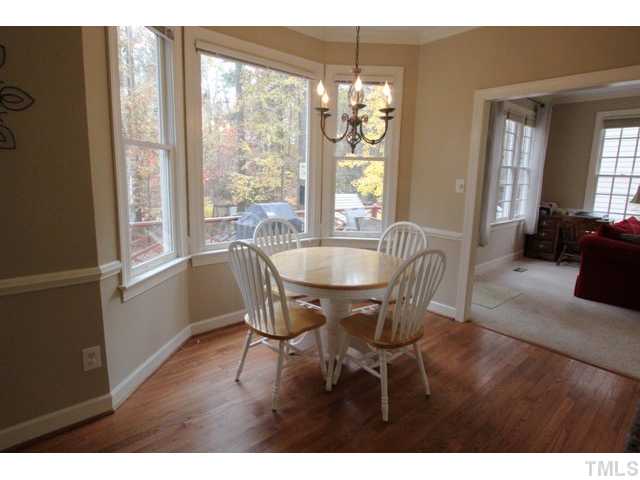 2708 Dahlgreen Road Raleigh, NC 27615 - Photo 7 of 25 a dining room with furniture a chandelier and wooden floor