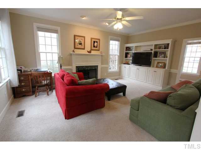 2708 Dahlgreen Road Raleigh, NC 27615 - Photo 8 of 25 a living room with furniture a flat screen tv and a fireplace