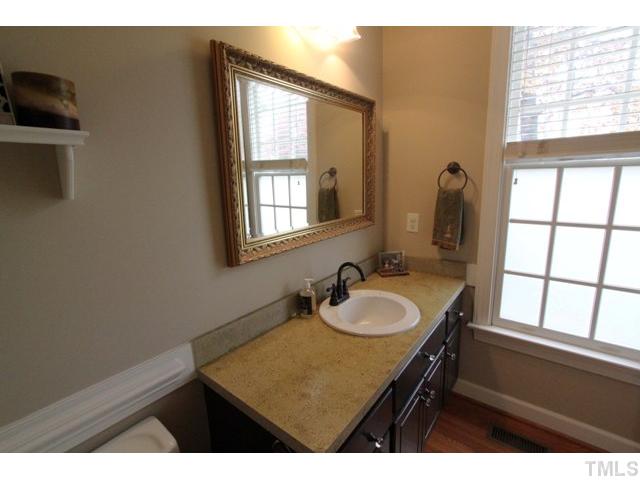 2708 Dahlgreen Road Raleigh, NC 27615 - Photo 10 of 25 a bathroom with a sink a vanity and a mirror