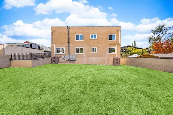 a view of a backyard with plants and a garden
