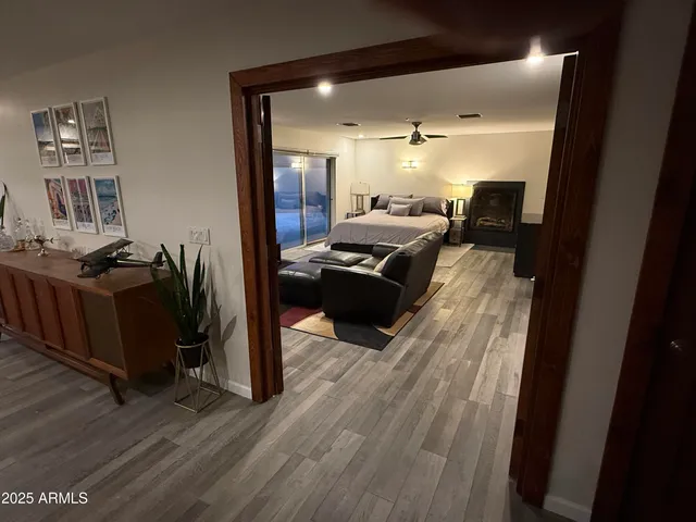 a bedroom with furniture and a wooden floor