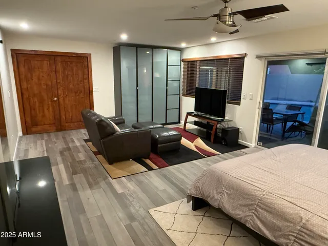 a bedroom with a bed window and couch