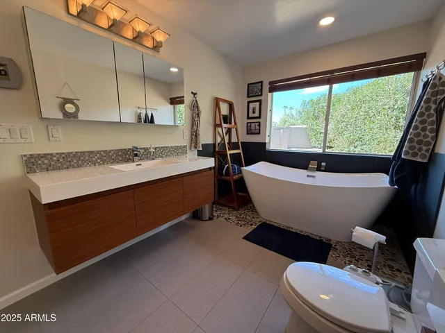 a bathroom with a sink mirror toilet and bathtub
