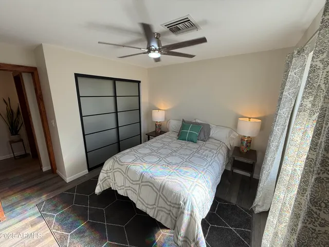 a bedroom with a bed and a mirror