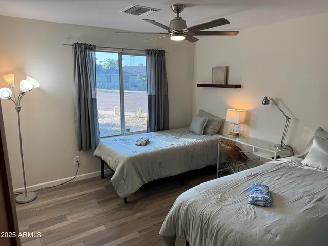 a bedroom with two beds and a chandelier