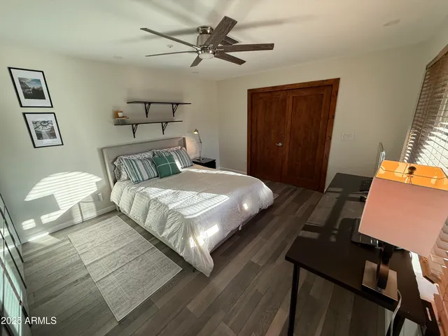 a bedroom with a bed and wooden furniture