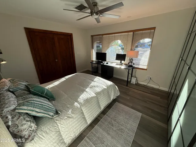 a bedroom with a bed window and dresser