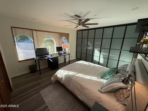 a bed sitting in a bedroom next to a window