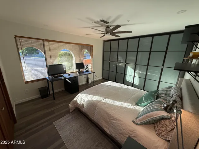 a bed sitting in a bedroom next to a window