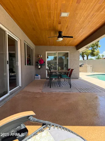 a view of a patio with table and chairs and potted plants