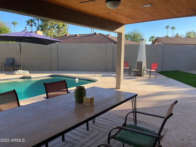 a view of a patio with table and chairs