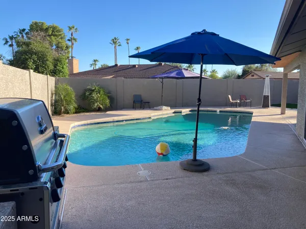 a view of a backyard with sitting area