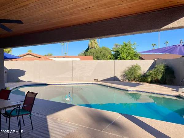 a view of swimming pool with seating space