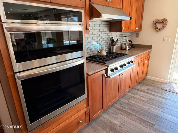 a kitchen with stainless steel appliances and cabinets