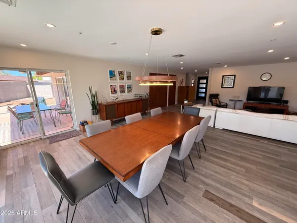 a dining room with furniture and wooden floor