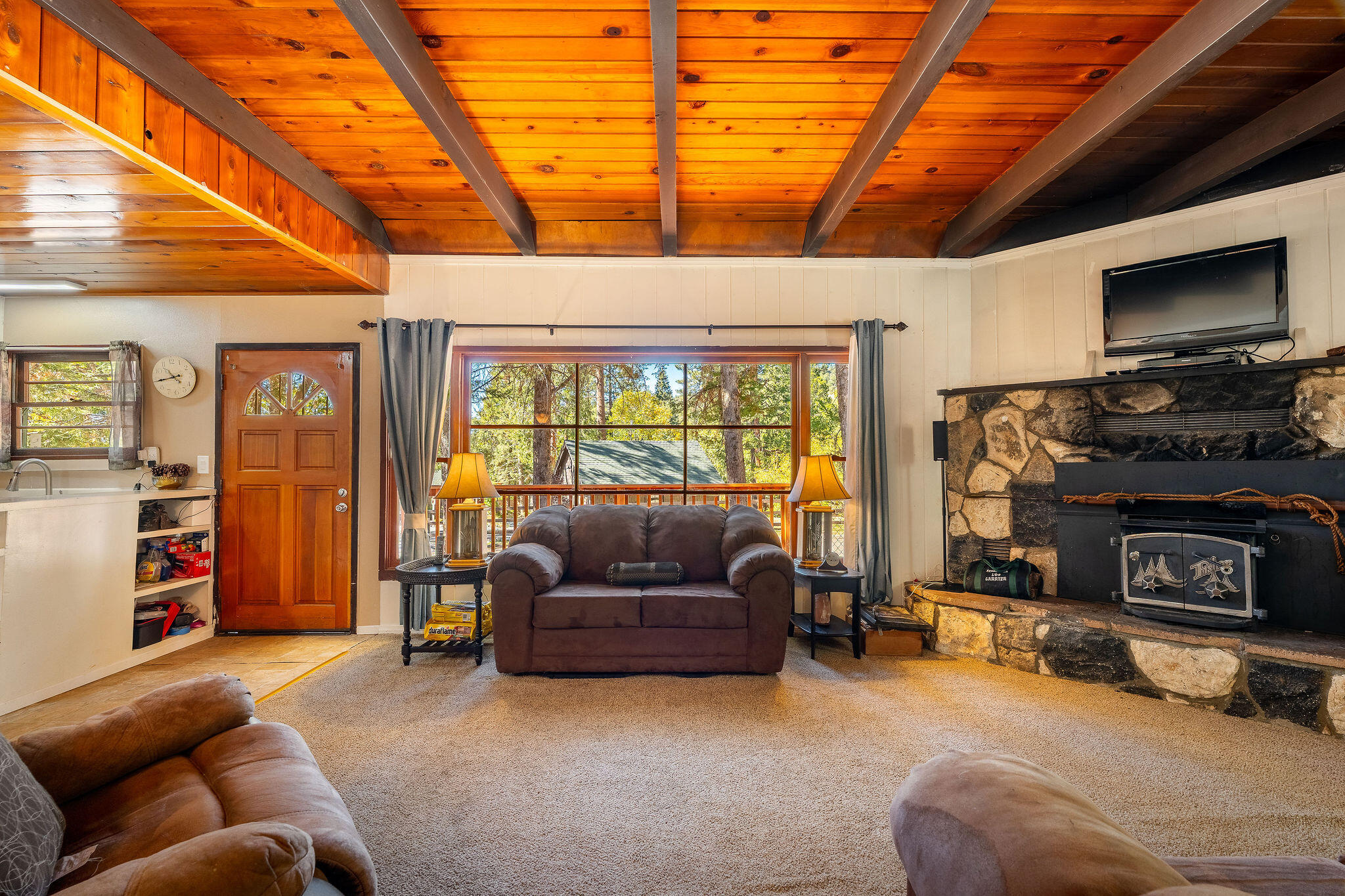 25290 Lodge Road Idyllwild, CA 92549 - Photo 12 of 46 a living room with furniture a flat screen tv and a fireplace
