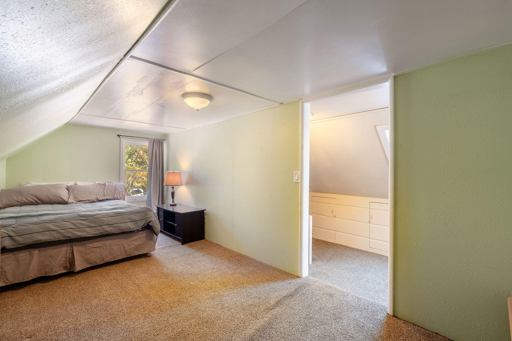 25290 Lodge Road Idyllwild, CA 92549 - Photo 22 of 46 a spacious bedroom with a bed and a view of bathroom