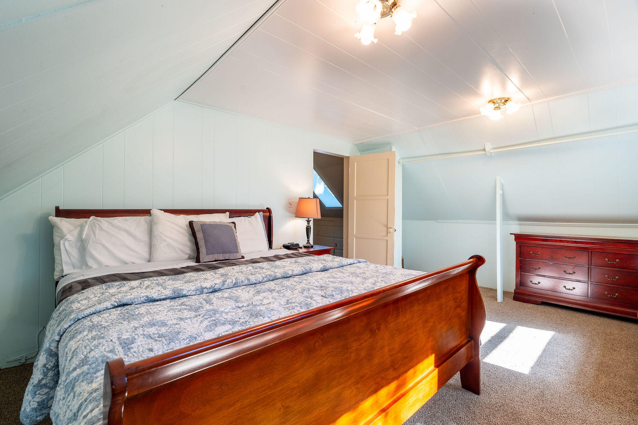 25290 Lodge Road Idyllwild, CA 92549 - Photo 25 of 46 a bedroom with a bed and a lamp with the dresser