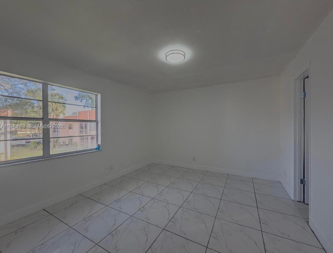 7610 Stirling Road, Unit 207F Davie, FL 33024 - Photo 11 of 22 an empty room with a empty space and window