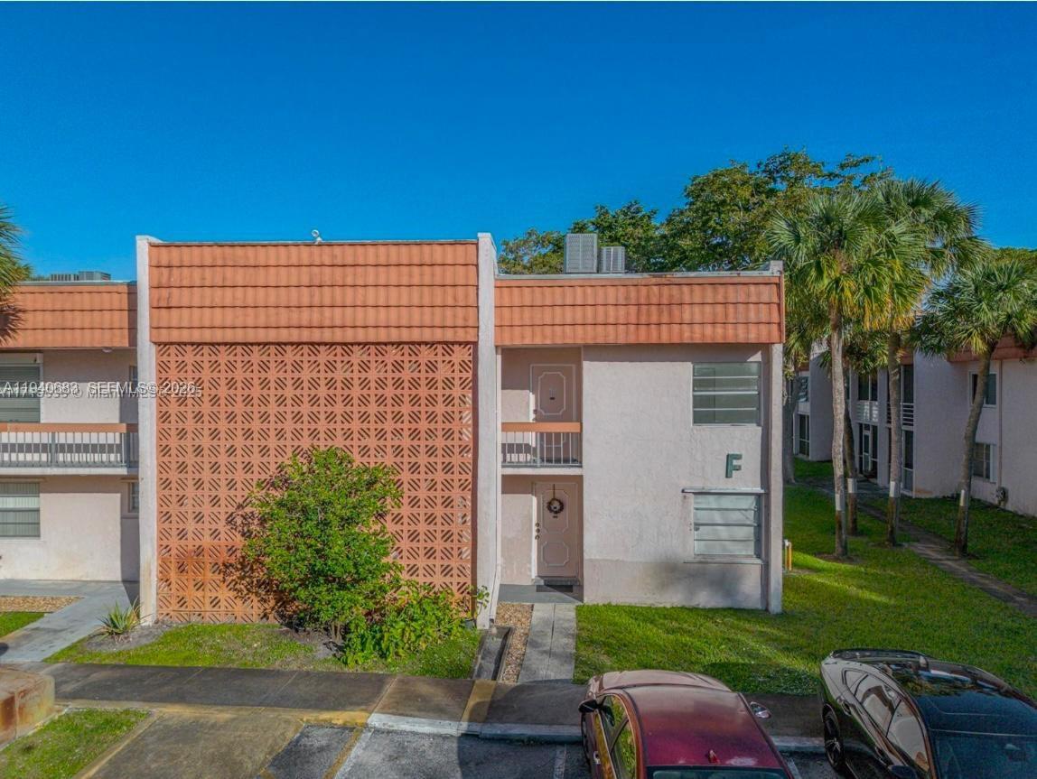 7610 Stirling Road, Unit 207F Davie, FL 33024 - Photo 17 of 22 front view of house with a yard