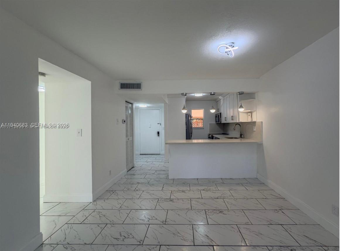 7610 Stirling Road, Unit 207F Davie, FL 33024 - Photo 8 of 22 a view of kitchen with white cabinets