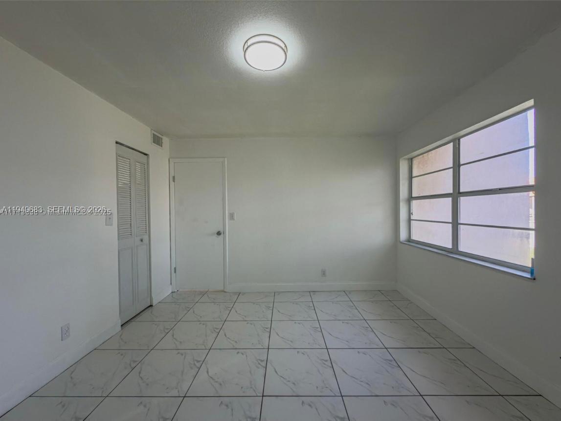 7610 Stirling Road, Unit 207F Davie, FL 33024 - Photo 9 of 22 an empty room with a empty space and windows
