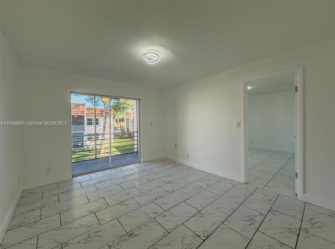 7610 Stirling Road, Unit 207F Davie, FL 33024 - Photo 10 of 22 an empty room with windows