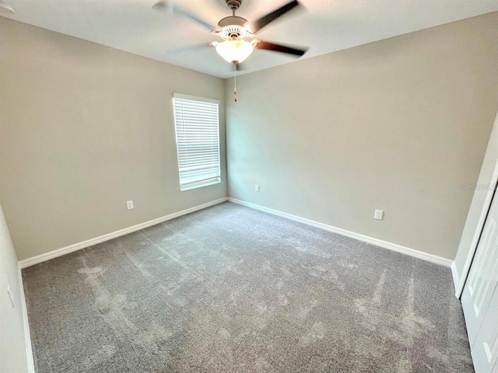 869 Anchor Bend Drive Ruskin, FL 33570 - Photo 11 of 23 an empty room with a window and a fan