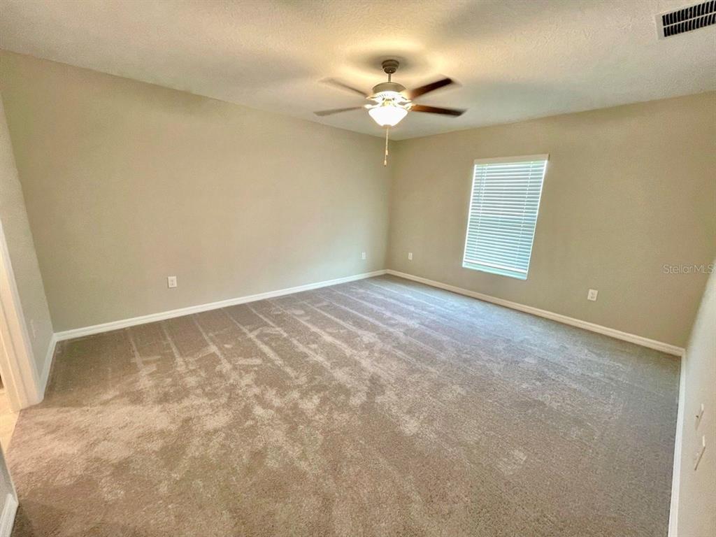 869 Anchor Bend Drive Ruskin, FL 33570 - Photo 14 of 23 an empty room with a chandelier fan