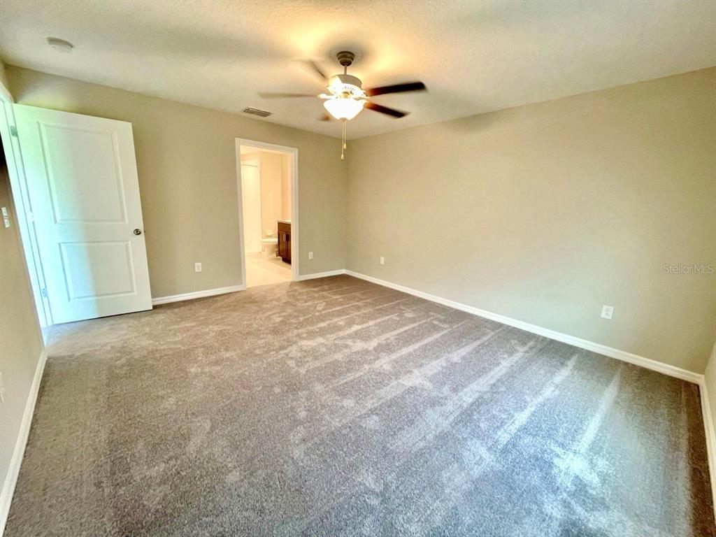 869 Anchor Bend Drive Ruskin, FL 33570 - Photo 15 of 23 an empty room with a ceiling fan and window