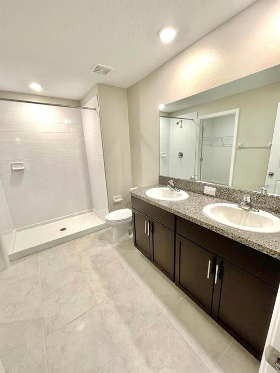 869 Anchor Bend Drive Ruskin, FL 33570 - Photo 17 of 23 a spacious bathroom with a double vanity sink a large mirror and a bathtub