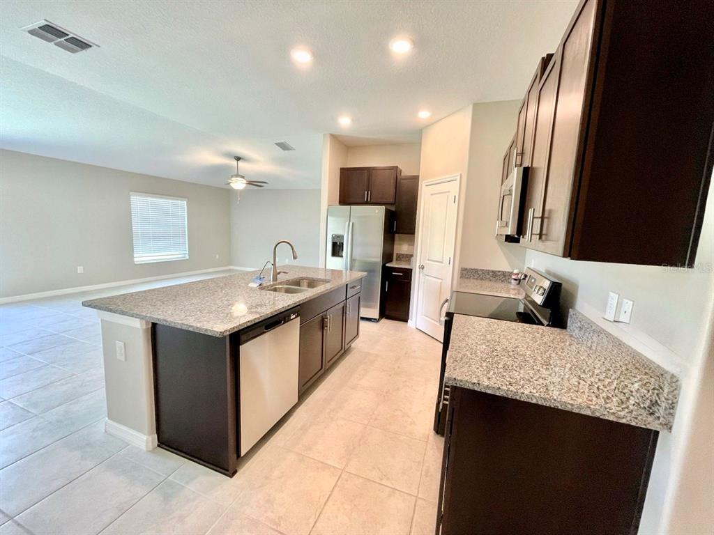 869 Anchor Bend Drive Ruskin, FL 33570 - Photo 3 of 23 a kitchen with a sink stove and refrigerator