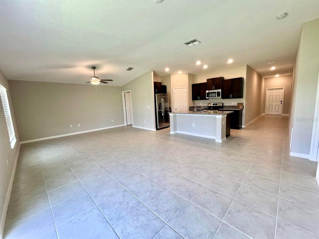 869 Anchor Bend Drive Ruskin, FL 33570 - Photo 5 of 23 a view of kitchen with kitchen island stainless steel appliances cabinets a sink and a counter top space