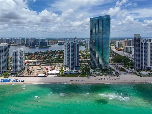 a bathroom with a granite countertop sink a mirror and shower
