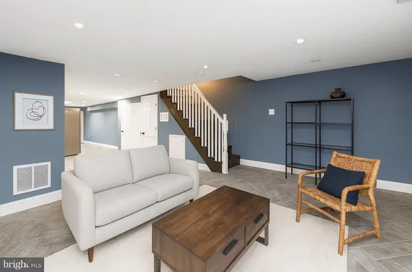 a living room with furniture and a rug