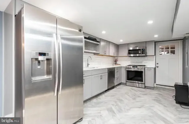 a kitchen with a refrigerator stove and oven