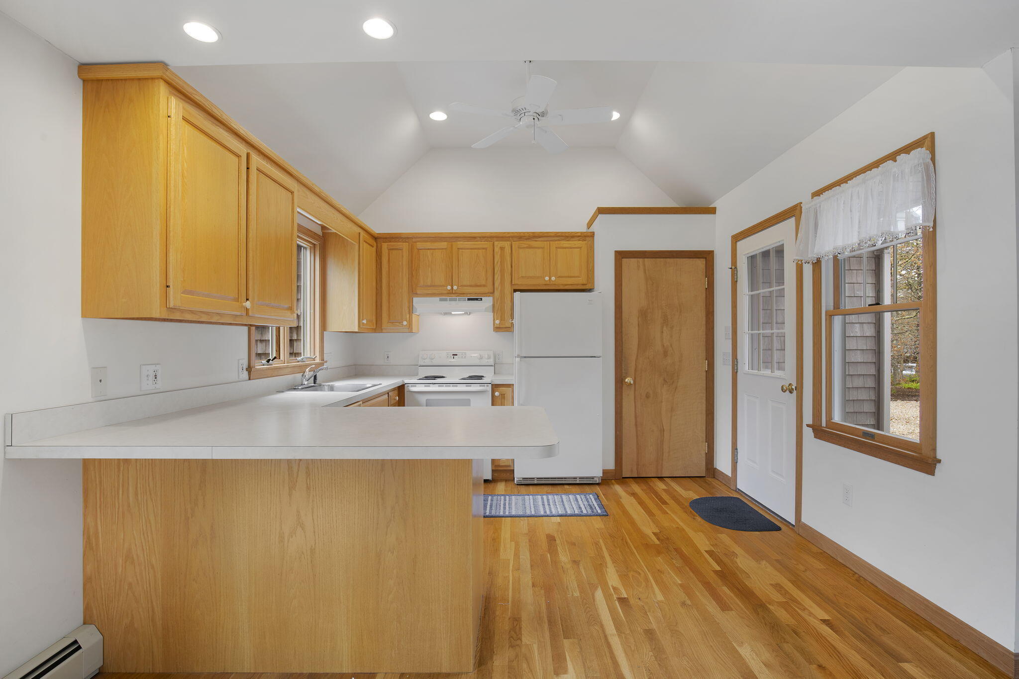 65 Whitney Road Eastham, MA 02642 - Photo 13 of 41 a kitchen with stainless steel appliances granite countertop a sink a refrigerator and a granite counter tops