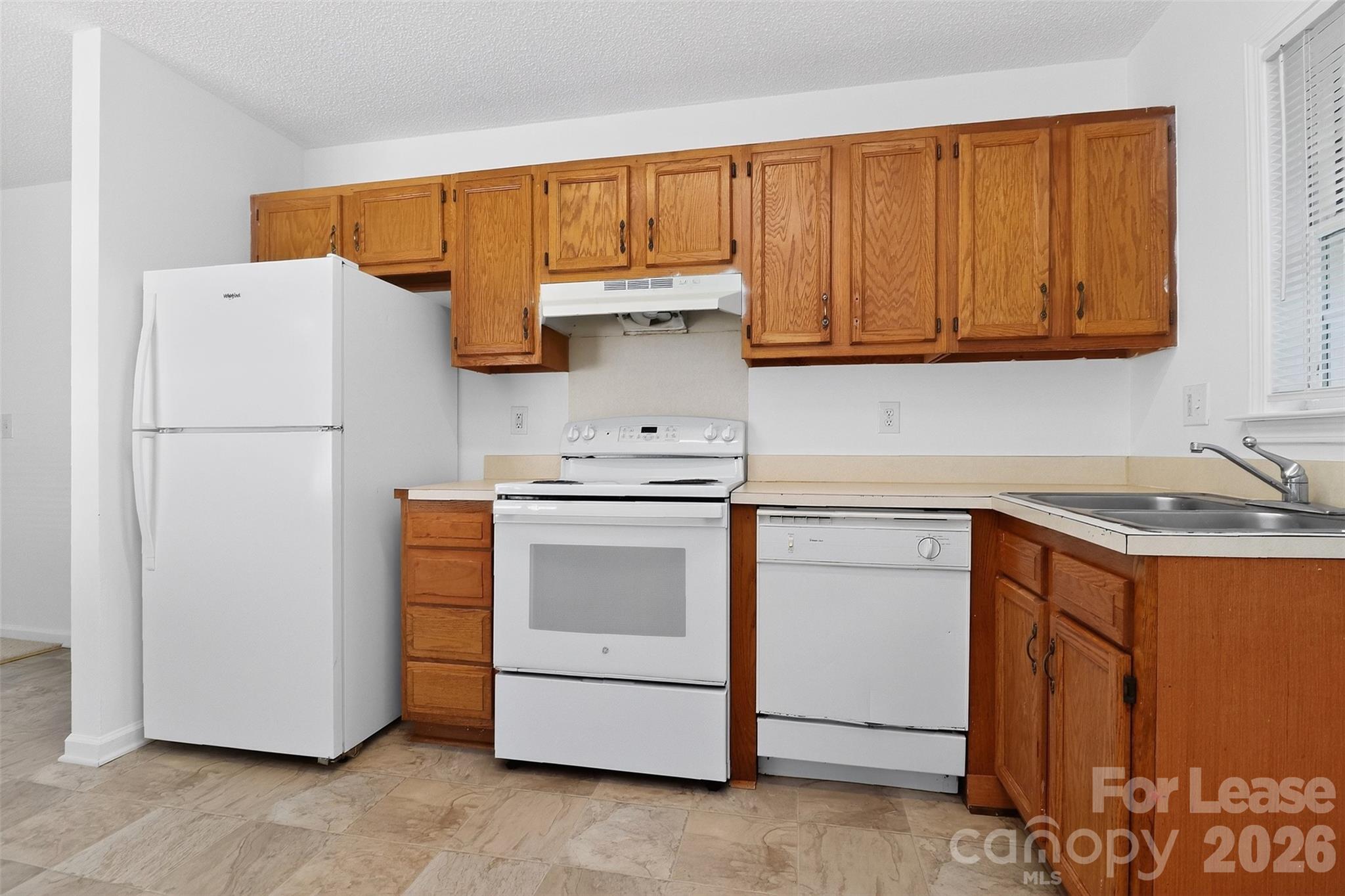 91-93 Sunderland Road Southwest, Unit 93 Concord, NC 28027 - Photo 14 of 30 a kitchen with a refrigerator sink stove and cabinets