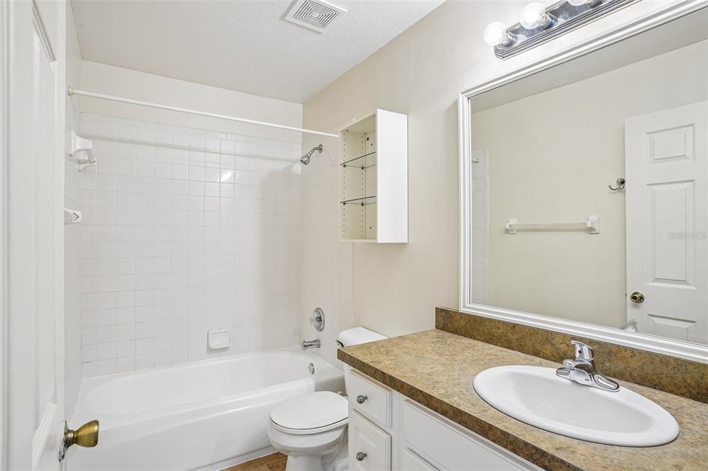 2596 Alclobe Circle Ocoee, FL 34761 - Photo 44 of 70 a bathroom with a granite countertop sink toilet a mirror and shower
