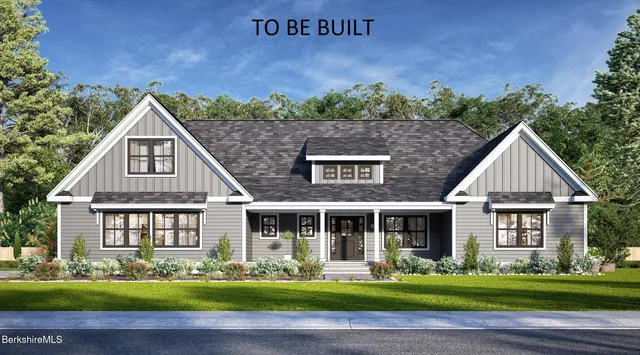 a front view of a house with a yard garden and outdoor seating