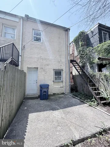 a white toilet sitting next to a bath tub and a shower