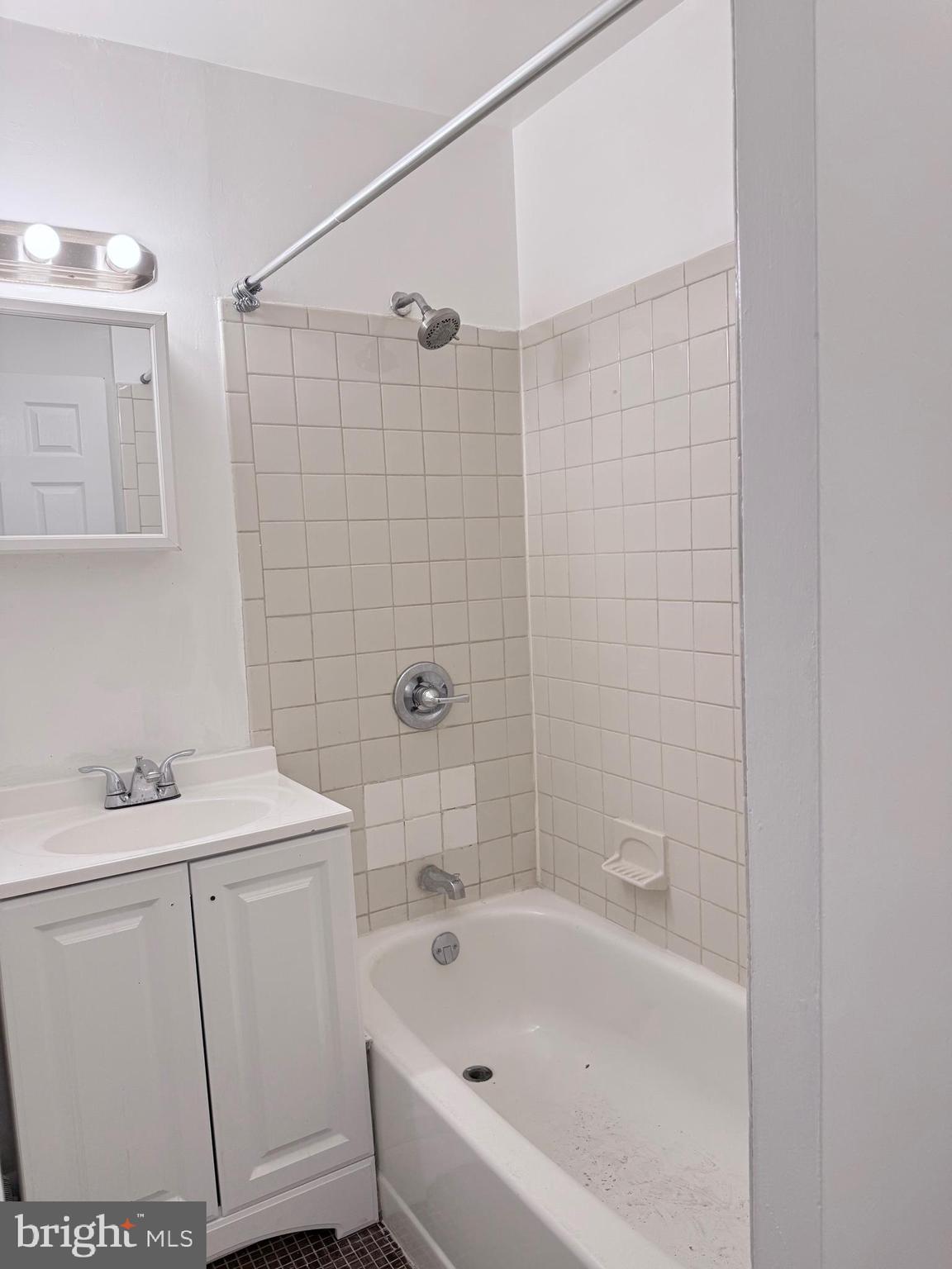 1820 West Fayette Street, Unit 1 Baltimore, MD 21223 - Photo 14 of 19 a bathroom with a sink a toilet and shower