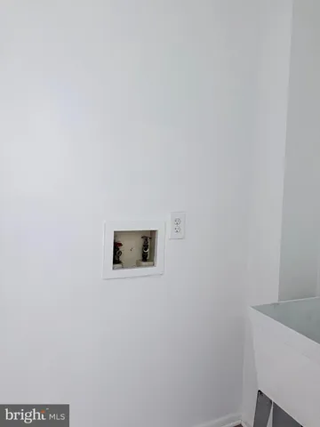 a view of room with window and wooden floor