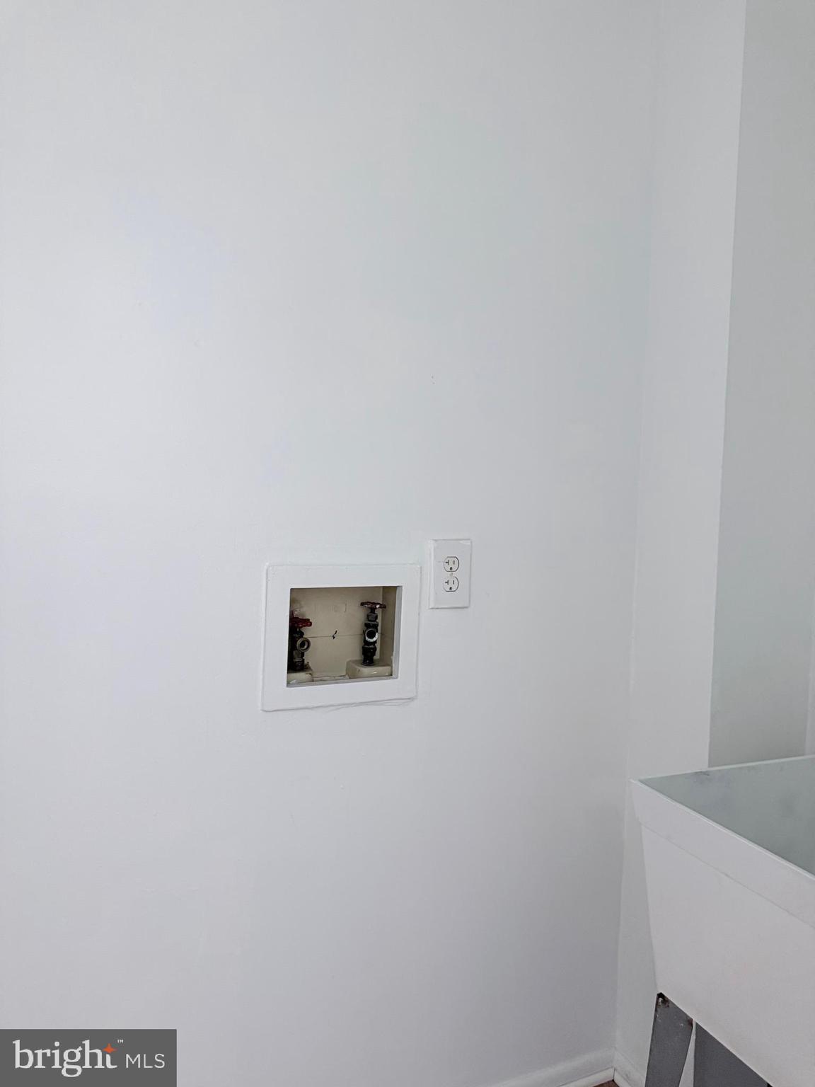 1820 West Fayette Street, Unit 1 Baltimore, MD 21223 - Photo 15 of 19 a wall with a microwave and cabinets