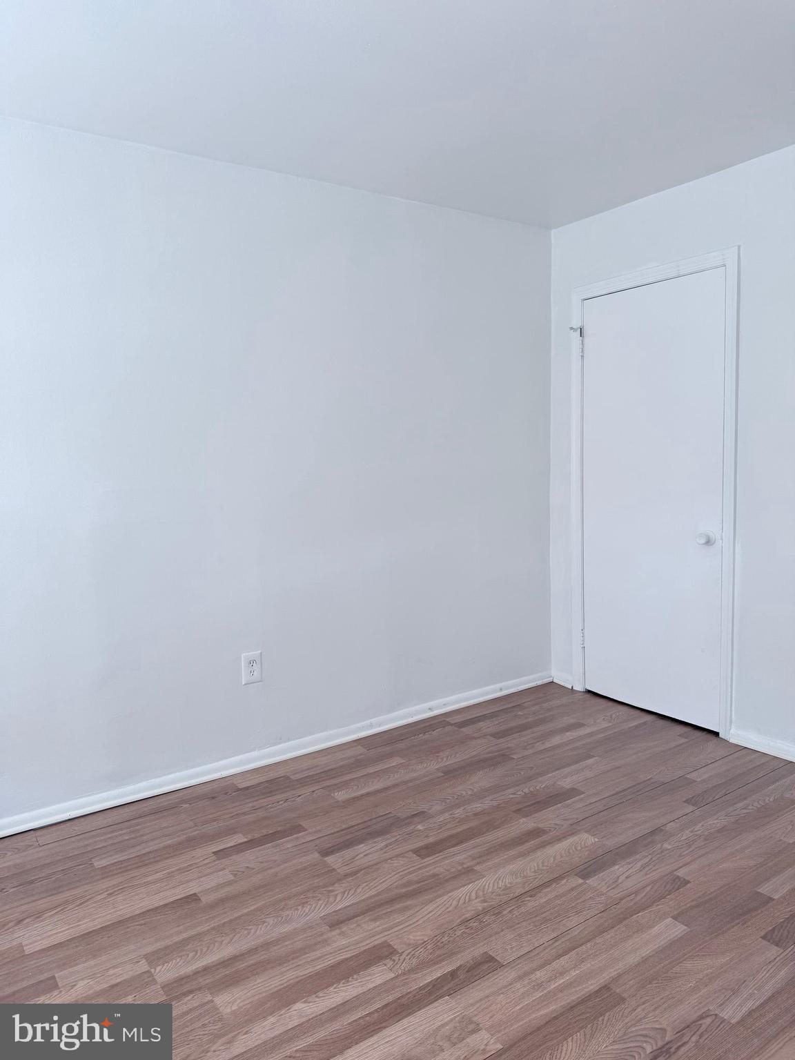 1820 West Fayette Street, Unit 1 Baltimore, MD 21223 - Photo 17 of 19 a view of an empty room with wooden floor