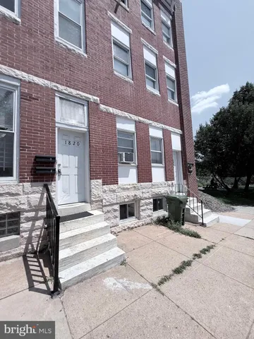 a view of a building with a bench in front of building