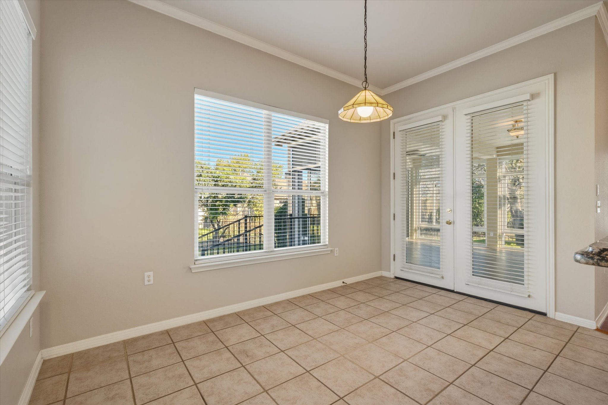 114 Whippoorwill Way Georgetown, TX 78633 - Photo 11 of 37 an empty room with windows and chandelier