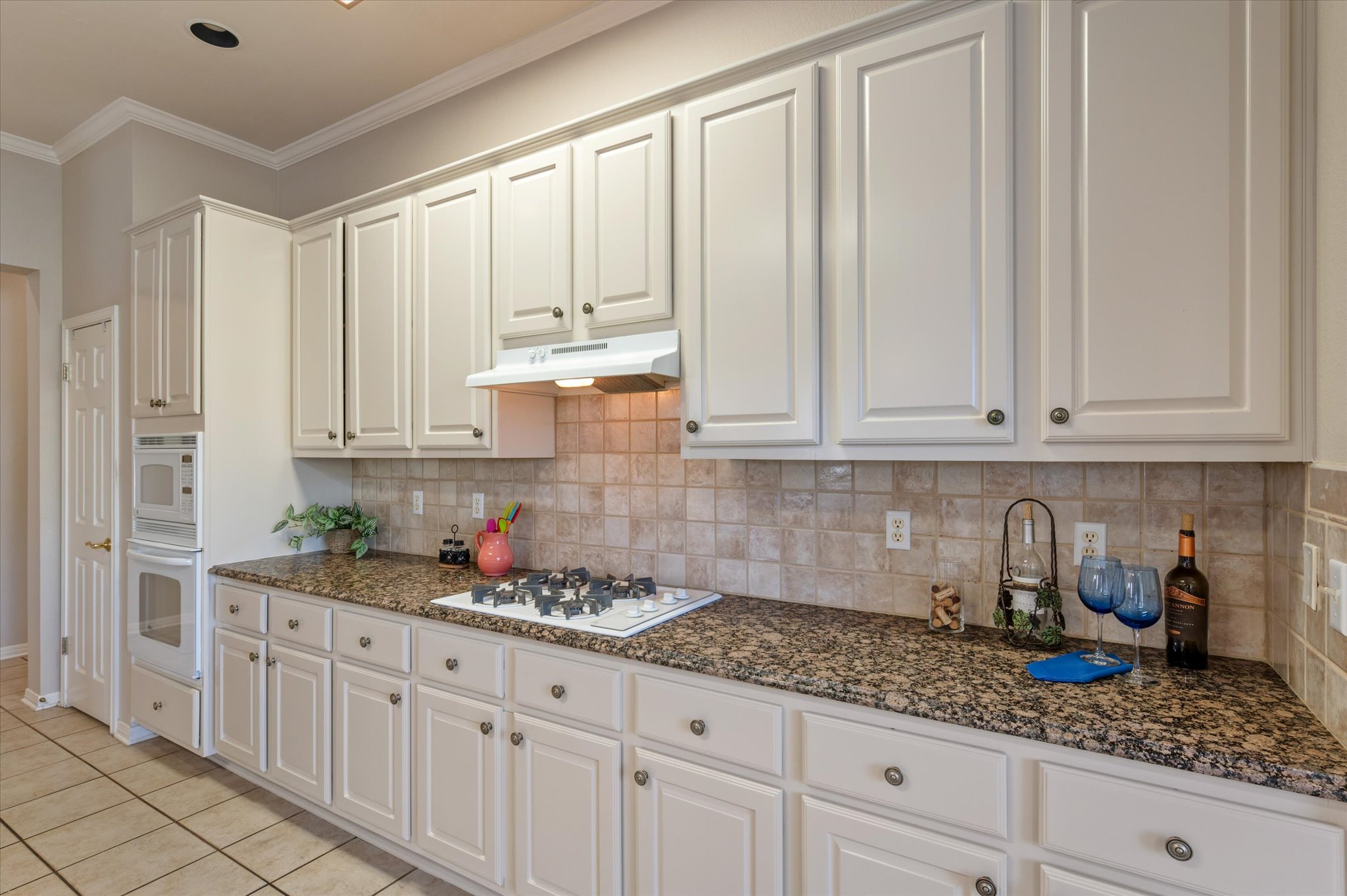 114 Whippoorwill Way Georgetown, TX 78633 - Photo 12 of 37 a kitchen with granite countertop white cabinets white appliances and sink
